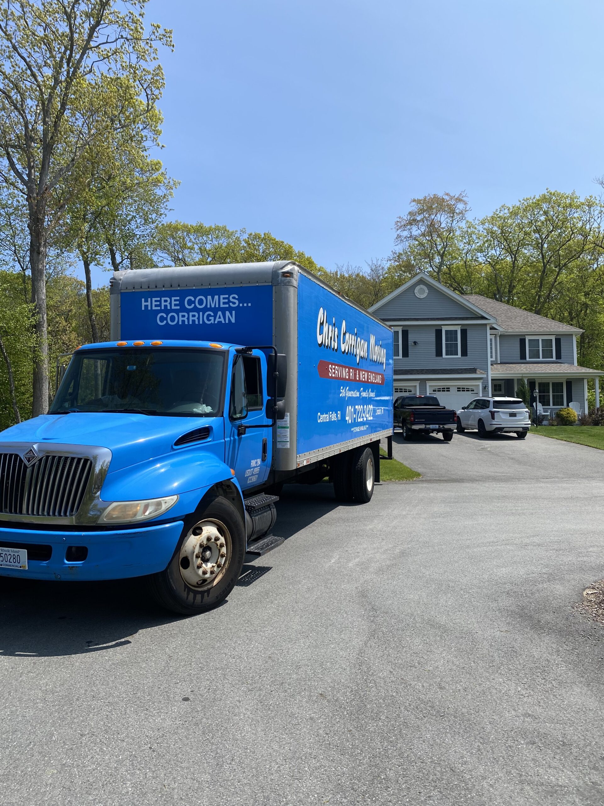 A Moving Company truck parked in front of a house.